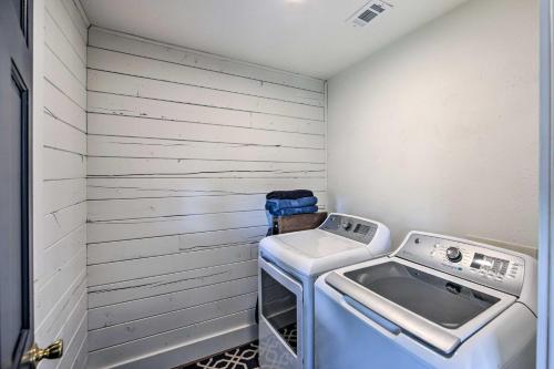 a small laundry room with a washer and dryer at Modern Kilgore Home with Yard about 14 Mi to Lake! in Kilgore