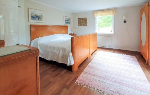 a bedroom with a large bed and a window at Beautiful Home In Älmhult With Kitchen in Älmhult