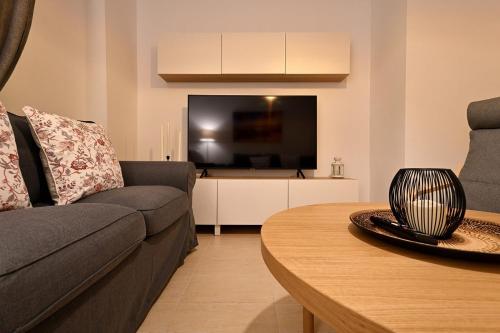 a living room with a couch and a table at Alojamiento Alcantara in Alora