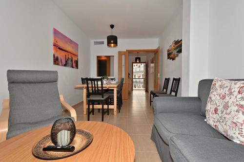 a living room with a couch and a table at Alojamiento Alcantara in Alora