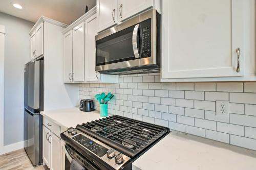a kitchen with a stove and a microwave at Ocean Shores Getaway with Fireplace and Hot Tub! in Ocean Shores