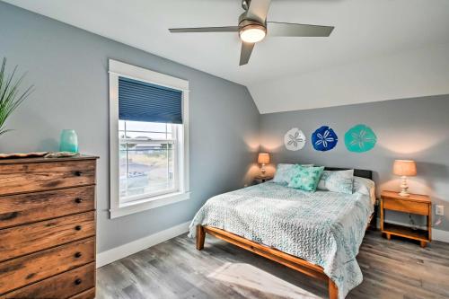 a bedroom with a bed and a dresser and a window at Ocean Shores Getaway with Fireplace and Hot Tub! in Ocean Shores