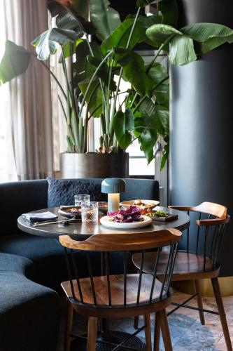 a table with plates of food on it in a living room at Radisson Collection Royal Hotel, Copenhagen in Copenhagen