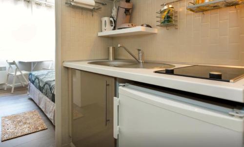 a kitchen with a sink and a counter top at Studio Vue Palais des Papes in Avignon