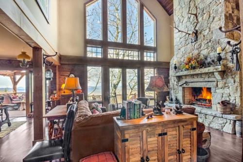 a living room with a couch and a fireplace at Luxury Sapphire Cabin Mtn Views and Resort Access! in Sapphire