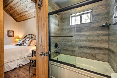 a bathroom with a tub next to a bedroom at Luxury Sapphire Cabin Mtn Views and Resort Access! in Sapphire