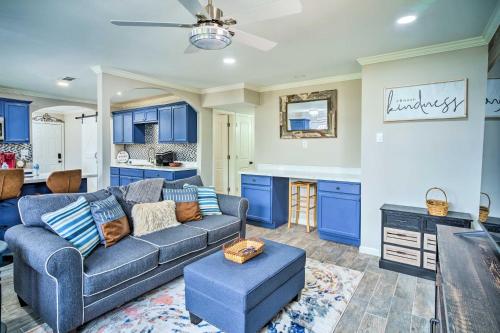 a living room with a couch and a kitchen at Blue Cottage in the Bayou with Private Yard! in Baton Rouge