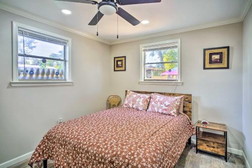 um quarto com uma cama e duas janelas em Blue Cottage in the Bayou with Private Yard! em Baton Rouge