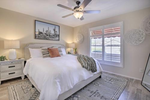 a bedroom with a white bed and a ceiling fan at Stunning Sun Lakes Retreat Less Than 1 Mi to Golfing! in Sun Lakes