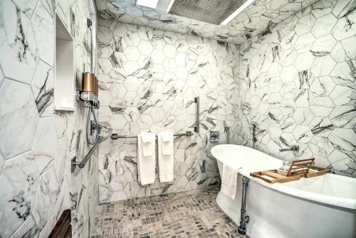 a bathroom with a white tub and a sink at Luxury Spa Retreat Private Courtyard and More! in Hastings