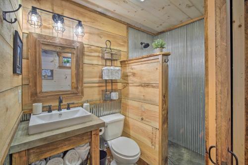 a bathroom with a white toilet and a sink at Stunning Cabin Getaway with Private Hot Tub! in Rising Fawn