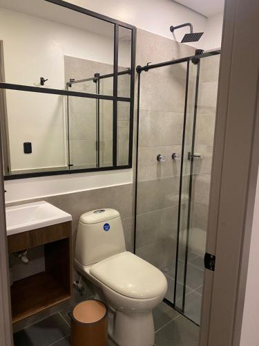 a bathroom with a toilet and a shower at Fence by Bernalo Hotels in Medellín