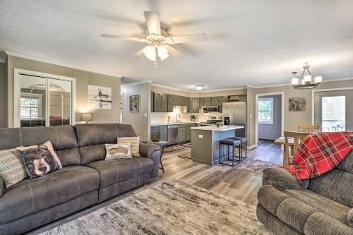a living room with a couch and a ceiling fan at Welcoming Boone Getaway Near Hiking and Skiing! in Boone