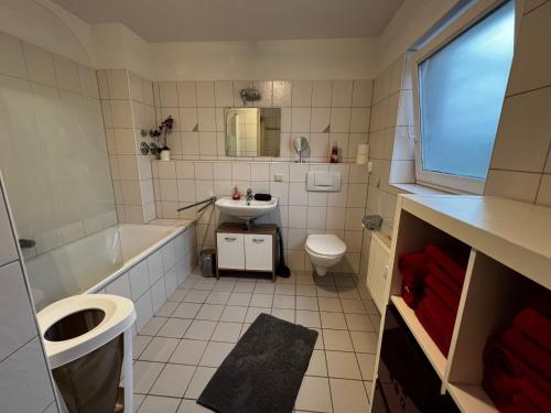 ein Badezimmer mit einer Badewanne, einem WC und einem Waschbecken in der Unterkunft Ferienwohnung Michelle klimatisiert Alemannenstr 1 in 77977 Rust in Rust