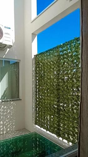 a room with a window with a green wall at Pousada Barbosa in Aparecida