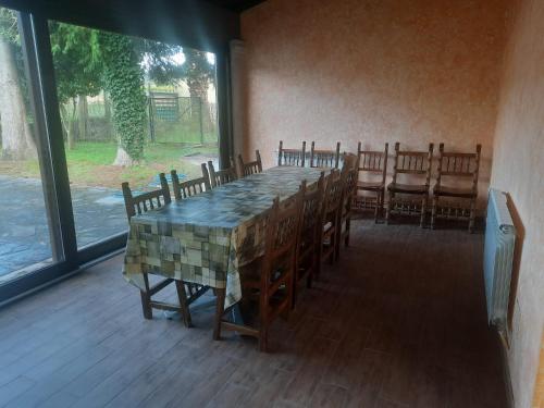 a dining room with a table and some chairs at Casa Manola in Teo