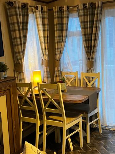 a dining room with a table and chairs at Seascape Horizon at Camber Sands in Camber