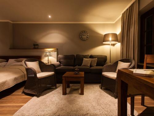 a living room with a couch and chairs and a table at Romantik Hotel zur Sonne in Badenweiler