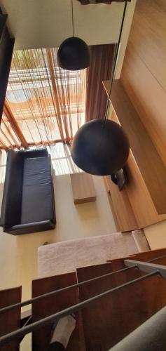 a room with pendant lights and a table and chairs at Grand Loft - Amazing Duplex 314 in Sao Paulo