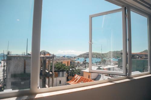 a view of a city from a window at Harbour Komodo Hotel in Labuan Bajo