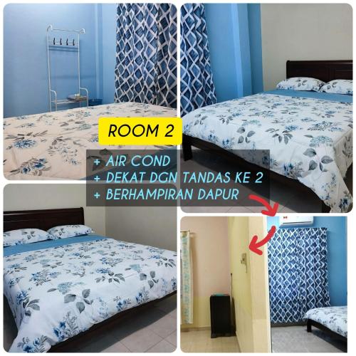 Schlafzimmer mit einem Bett mit einer blauen und weißen Bettdecke in der Unterkunft Ace Inn Guest House in Rantau Panjang