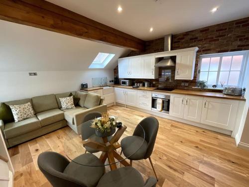 a large living room with a couch and a table at Apt D in Old Grade 2 Converted Farmhouse in Market Weighton