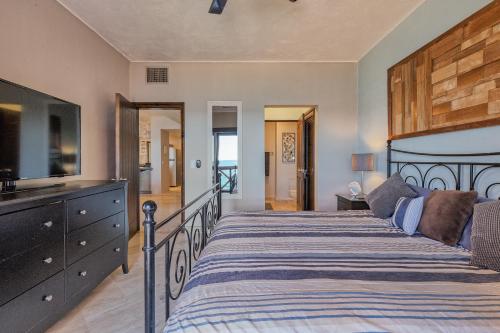 a bedroom with a large bed and a television at Marina Pinacate B-201 in Puerto Peñasco