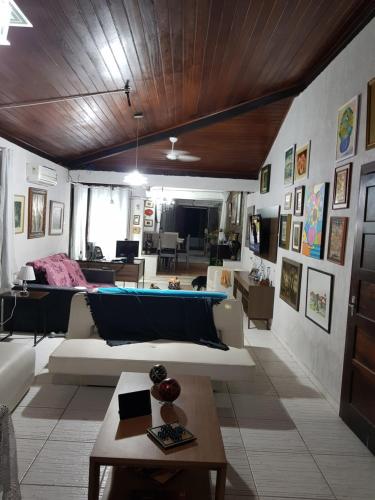 a living room with a couch and a table at Casa Ilha de Itaparica in Itaparica