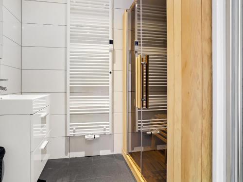 a bathroom with a sink and a glass closet at Attractive holiday home in Noordwolde with sauna in Noordwolde