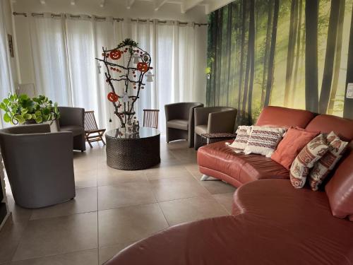 a living room with a couch and some chairs at Holiday home in Koekelare in Koekelare