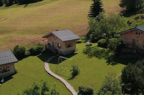 an aerial view of a house with a kite in a yard at Cosy chalet with garden in Notre-Dame-de-Bellecombe