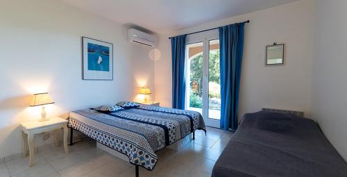 - une chambre avec un lit et une fenêtre dans l'établissement Au coeur de l'arriere Pays Rez de chaussé de Villa DOMAINE A PRESA, à Sartène