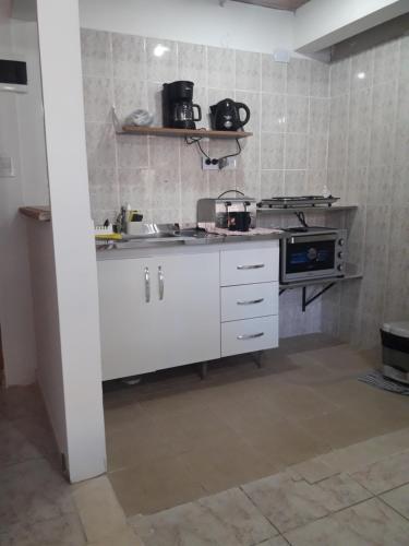 a kitchen with a sink and a stove at Departamentos Paisaje del Beagle in Ushuaia
