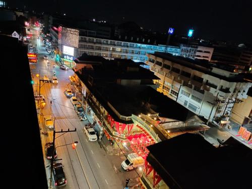 a city street at night with traffic and buildings at The Harbour Front Hotel in Suratthani
