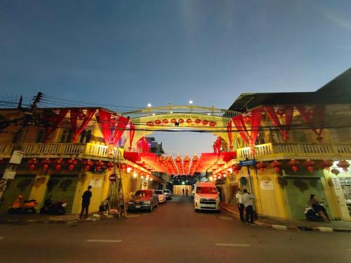 a city street with cars parked under a bridge at The Harbour Front Hotel in Suratthani