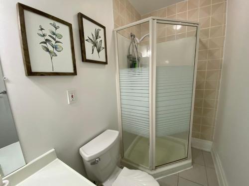 a bathroom with a toilet and a glass shower at Yorkmills and Bayview !C Cozy & Stylish Private Bdr with Shared Bathroom in Toronto