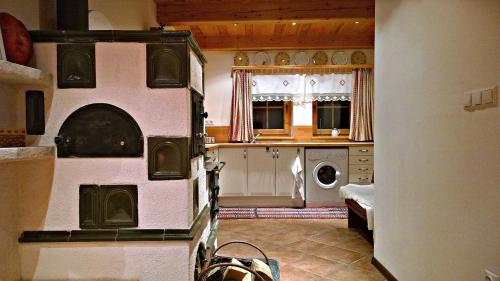 a kitchen with a washer and dryer in a room at Chalupka na Orave in Dolný Kubín