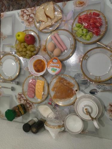 a table with many plates of food on it at Guest House Safina-S&D in Samarkand