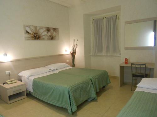 Posteľ alebo postele v izbe v ubytovaní Hotel Concorde