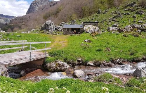 a bridge over a stream with a building on a hill at Gorgeous Home In Osse-En-Aspe With Wifi in Osse-en-Aspe