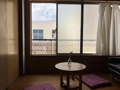 a room with a table in front of a window at Torii-Kuguru in Okayama