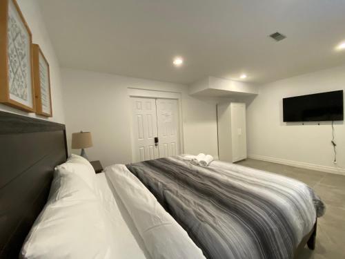 a bedroom with a large bed with a flat screen tv at Yorkmills and Bayview !B Spacious and Stylish Private Bdr with Shared Bathroom in Toronto