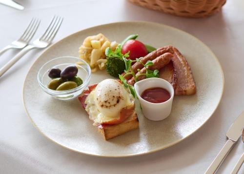 a plate of food with an egg and toast at Pearl Star Hotel ATAMI in Atami