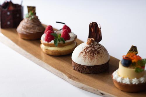 a group of desserts on a wooden tray at Pearl Star Hotel ATAMI in Atami