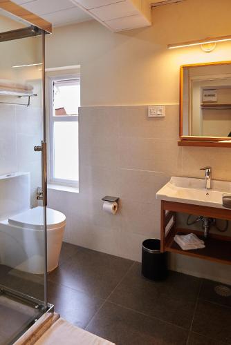 a bathroom with a tub and a sink and a toilet at The Willows Hotel, Bhutan in Thimphu