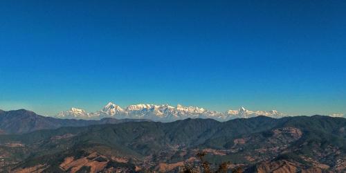 a view of a mountain range with snow covered mountains at Meraki - Entire 2BHK Villa With Himalayan Views in Rānīkhet