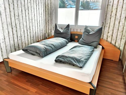 a bed with two pillows on it in a room at Fewo Albglück in Albstadt