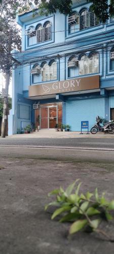 a blue building with a sign that reads clery at Glory Hotel Cubao in Manila