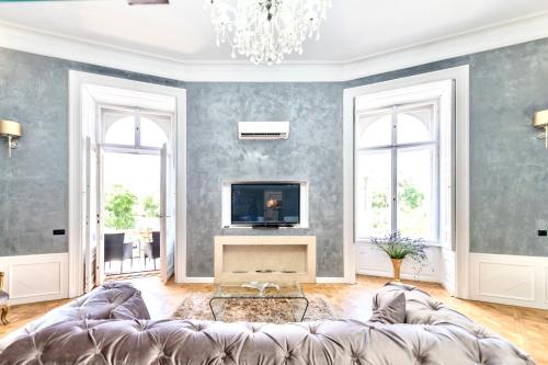 a living room with a couch and a tv at TOP Luxury Suites in Budapest