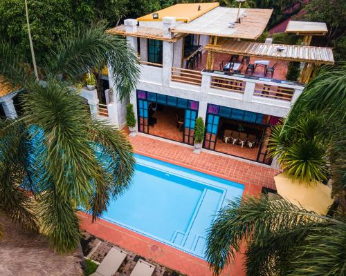 an aerial view of a house with a swimming pool at Baanpong Lodge in San Kamphaeng
